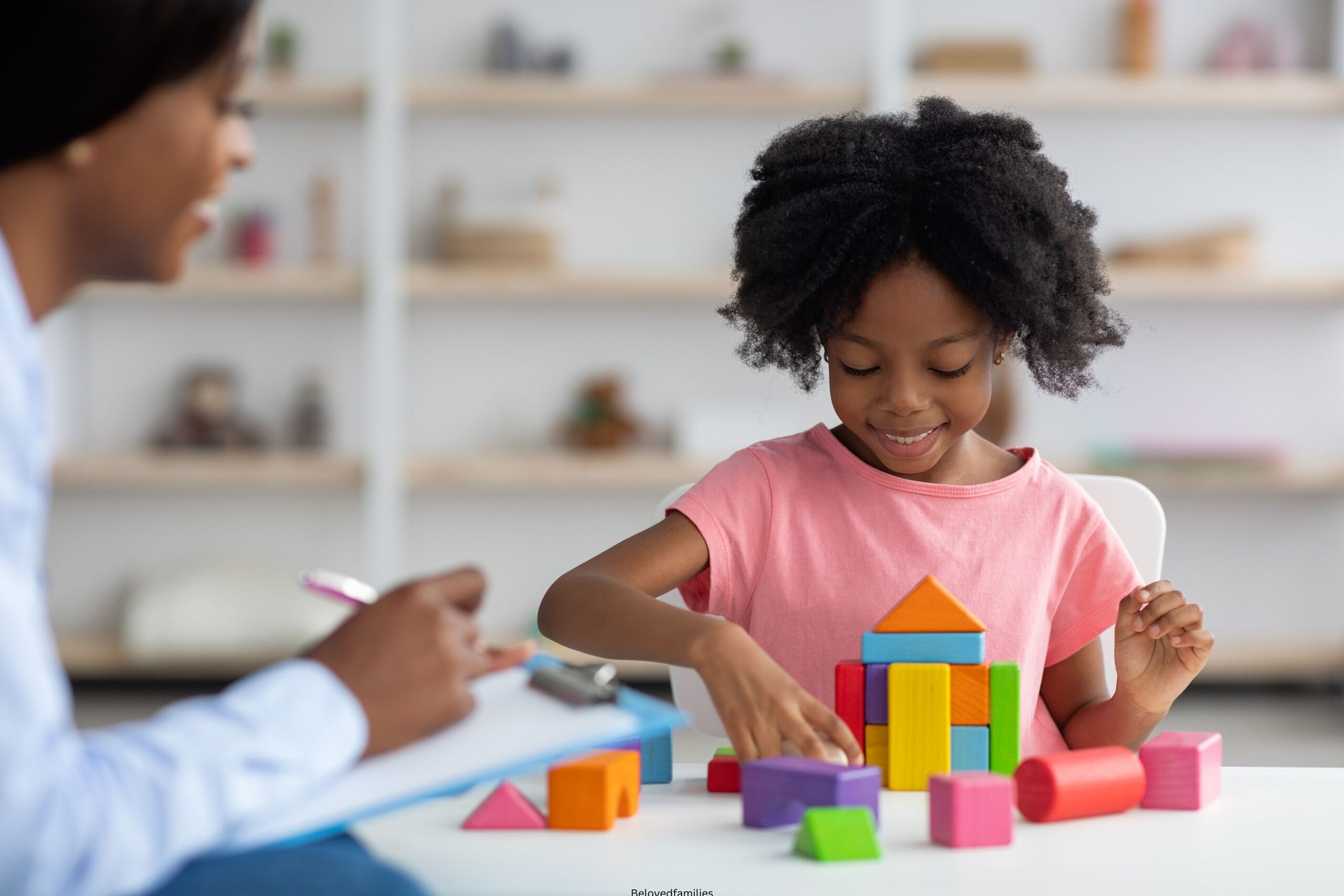 Child development specialist observing cheerful child preschooler