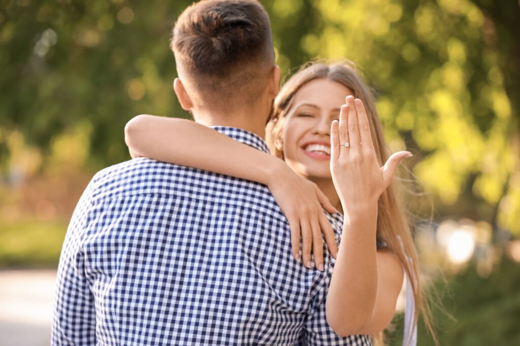 Happy Engaged Couple Hugging Outdoors